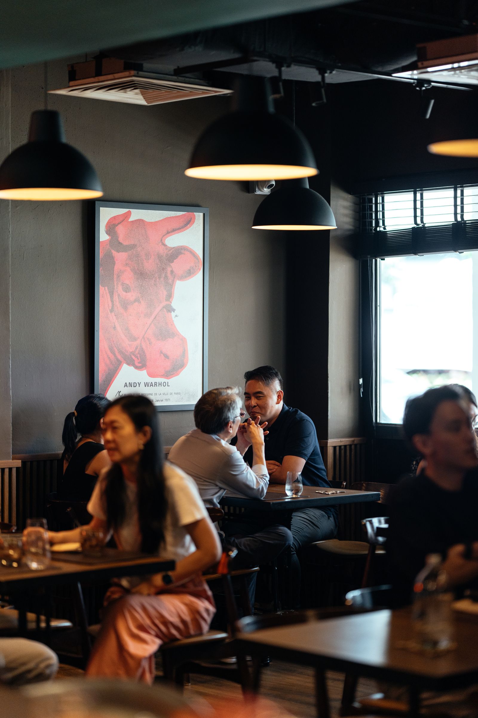 The dining room under the Andy Warhol cow print, full through dinner service